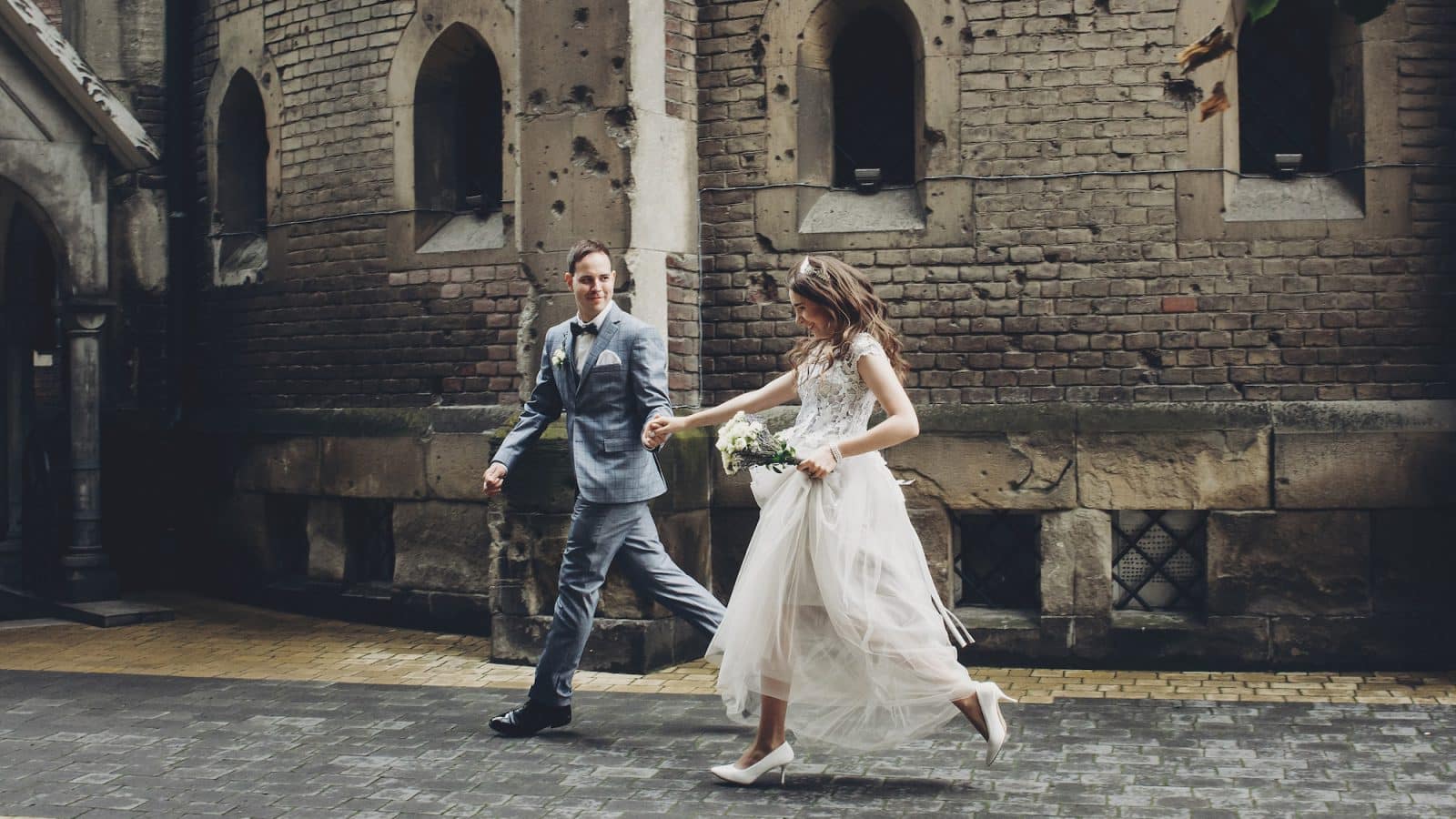 Beautiful emotional wedding couple running and smiling in european city. Provence wedding